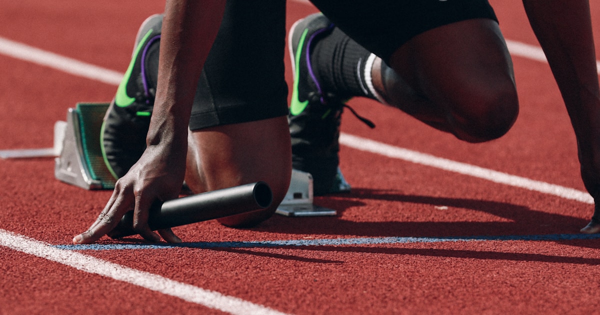 Curling rocks on ice with brush